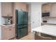 Kitchen boasts stainless steel appliances, wooden cabinets, a beverage station, and stylish countertops at 386 Monteith Dr, Chapel Hill, NC 27516