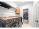 Modern laundry room with front loading washer and dryer, plus a walk-in closet and extra storage at 386 Monteith Dr, Chapel Hill, NC 27516