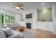 Bright living room featuring a modern fireplace, a ceiling fan, and a view of the deck at 386 Monteith Dr, Chapel Hill, NC 27516