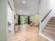 Open-concept living space with wood floors, stairs, and a sliding glass door to the backyard at 386 Monteith Dr, Chapel Hill, NC 27516