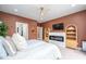 Bedroom featuring an electric fireplace with an entertainment center and an ensuite bathroom at 386 Monteith Dr, Chapel Hill, NC 27516