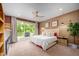 Spacious main bedroom with private balcony access, ceiling fan, and neutral carpeting at 386 Monteith Dr, Chapel Hill, NC 27516