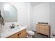 Stylish powder room with decorative mirror, wood vanity and countertop, and modern fixtures at 386 Monteith Dr, Chapel Hill, NC 27516
