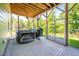 Relaxing screened-in porch with a hot tub and view of the lush surrounding trees at 386 Monteith Dr, Chapel Hill, NC 27516