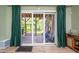 Screened porch with outdoor seating area, wood floors, and view of the landscaped backyard at 386 Monteith Dr, Chapel Hill, NC 27516