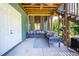 Inviting screened porch featuring a cushioned seating area with many pillows at 386 Monteith Dr, Chapel Hill, NC 27516