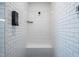 Modern shower featuring white subway tile, built-in bench, and sleek black fixtures at 386 Monteith Dr, Chapel Hill, NC 27516