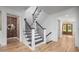 Elegant staircase with dark wood treads and white risers, complemented by light wood floors at 386 Monteith Dr, Chapel Hill, NC 27516