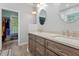 Bathroom featuring double sinks, wood cabinets, and access to a walk-in closet at 395 Timberlands Dr, Louisburg, NC 27549