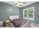 This bedroom has a ceiling fan, a window looking out on the backyard, and neutral carpet at 395 Timberlands Dr, Louisburg, NC 27549