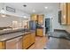 Spacious kitchen with granite counters, stainless steel appliances, and breakfast bar seating at 395 Timberlands Dr, Louisburg, NC 27549