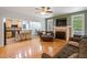 Comfortable living room with fireplace, hardwood floors, and open layout to the kitchen and dining area at 395 Timberlands Dr, Louisburg, NC 27549