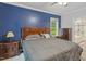 Spacious main bedroom with ensuite bathroom access, a dark accent wall, and natural lighting at 395 Timberlands Dr, Louisburg, NC 27549
