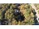 Aerial view of property with mature trees, offering privacy and a serene setting near a golf course at 403 Rutherglen Dr, Cary, NC 27511