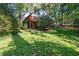 A treed backyard has an upper wooden deck and mature landscaping at 403 Rutherglen Dr, Cary, NC 27511
