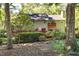Rear exterior of home featuring a deck surrounded by mature trees and landscaping at 403 Rutherglen Dr, Cary, NC 27511