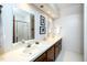Well-lit bathroom with double sinks, large mirrors and a walk-in shower at 403 Rutherglen Dr, Cary, NC 27511