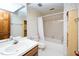 Bathroom with a single sink, patterned wallpaper, and a shower-tub combo at 403 Rutherglen Dr, Cary, NC 27511