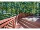 Exterior view of the deck with lattice railing overlooking the green landscaped backyard at 403 Rutherglen Dr, Cary, NC 27511