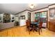 A dining area that opens to living room with wood floors, a round table with chairs, and a view of the outdoors at 403 Rutherglen Dr, Cary, NC 27511