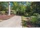 Long driveway leading to a charming home surrounded by mature trees and established landscaping at 403 Rutherglen Dr, Cary, NC 27511