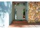 Charming entryway features a stone accent wall and wood door with sidelights and transom at 403 Rutherglen Dr, Cary, NC 27511