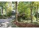 Well-maintained home with a lush front yard, mature trees, and an inviting driveway at 403 Rutherglen Dr, Cary, NC 27511