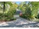Beautiful home with attached garage nestled among trees, offering privacy and curb appeal at 403 Rutherglen Dr, Cary, NC 27511