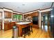 A kitchen with wood cabinets, granite countertops, stainless steel appliances, and a center island with seating at 403 Rutherglen Dr, Cary, NC 27511