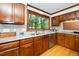 A kitchen with wood cabinets, granite countertops, a stainless steel dishwasher and hardwood floors at 403 Rutherglen Dr, Cary, NC 27511