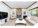 A living room featuring a stone fireplace, hardwood floors, recessed lighting and a neutral color palette at 403 Rutherglen Dr, Cary, NC 27511
