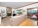 A living room with a stone fireplace, hardwood floors, and a sliding door with access to the outdoors at 403 Rutherglen Dr, Cary, NC 27511