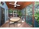 Screened-in porch features wood ceiling, table with chairs, and sliding glass doors at 403 Rutherglen Dr, Cary, NC 27511