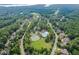 Aerial view of the neighborhood showcasing the pool, tennis courts, and lush greenery at 410 Mountain Laurel, Chapel Hill, NC 27517