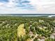 Beautiful aerial view of the neighborhood, showing the golf course, lake, and surrounding trees at 410 Mountain Laurel, Chapel Hill, NC 27517