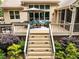 View of a deck with lounge furniture, an umbrella, a grill, and stairs leading to the backyard at 410 Mountain Laurel, Chapel Hill, NC 27517