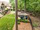 View of backyard including the gazebo with seating, a putting green, and mature trees at 410 Mountain Laurel, Chapel Hill, NC 27517