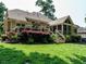Large backyard with a patio, greenery, landscaping and a screened-in porch at 410 Mountain Laurel, Chapel Hill, NC 27517