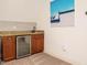 Bar area featuring granite counters, built in mini-fridge and modern decor at 410 Mountain Laurel, Chapel Hill, NC 27517