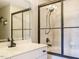 Bright bathroom featuring a black framed glass shower, white vanity, and modern fixtures at 410 Mountain Laurel, Chapel Hill, NC 27517