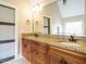 Bathroom with double sink vanity, granite countertops, and warm wood cabinetry at 410 Mountain Laurel, Chapel Hill, NC 27517