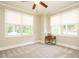 Bright bedroom with carpet, two windows providing natural light, and a ceiling fan at 410 Mountain Laurel, Chapel Hill, NC 27517