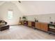 Bonus room showcasing modern shelving, stylish decor, and cozy reading space at 410 Mountain Laurel, Chapel Hill, NC 27517