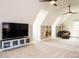 Spacious bonus room featuring guitars, entertainment center and a leather sofa at 410 Mountain Laurel, Chapel Hill, NC 27517