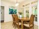 Charming dining room with hardwood table set with seating for four and decorative art at 410 Mountain Laurel, Chapel Hill, NC 27517