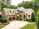 Beautiful home featuring stone accents, a circular driveway and a two-car garage at 410 Mountain Laurel, Chapel Hill, NC 27517