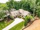Stunning stone home featuring an attached two-car garage, complemented by lush landscaping and a long driveway at 410 Mountain Laurel, Chapel Hill, NC 27517