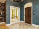 Inviting foyer featuring decorative doors, textured wallpaper, and tile flooring at 410 Mountain Laurel, Chapel Hill, NC 27517