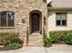 Charming home entrance with stone steps and meticulously landscaped bushes at 410 Mountain Laurel, Chapel Hill, NC 27517