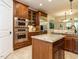 Spacious kitchen with wood cabinetry, granite countertops, stainless steel appliances and island at 410 Mountain Laurel, Chapel Hill, NC 27517